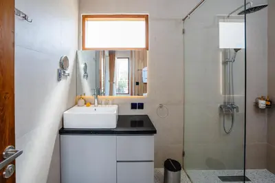 a bathroom with a sink and a shower at Villa Waldo - 6 bedroom High End Luxury Villa in Batu Belig, Seminyak in Canggu