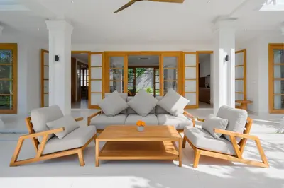 a living room with a couch and two chairs and a table at Amenara Estate by LifestyleRetreats in Canggu