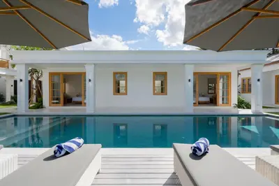 a villa with a swimming pool and a house at Amenara Estate by LifestyleRetreats in Canggu