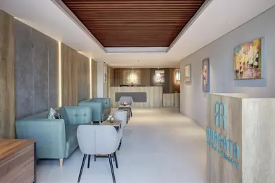 a hospital lobby with blue chairs and a waiting room at Anagata 3 Tanjung Benoa Bali in Nusa Dua