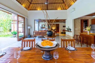 a dining room with a table with wine glasses at Magnificent 4 BR Private Pool Villa NE10 in Jimbaran