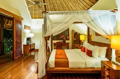 a bedroom with a canopy bed and a desk at Magnificent 4 BR Private Pool Villa NE10 in Jimbaran