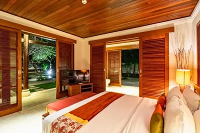 a bedroom with a large bed and a television at Magnificent 4 BR Private Pool Villa NE10 in Jimbaran