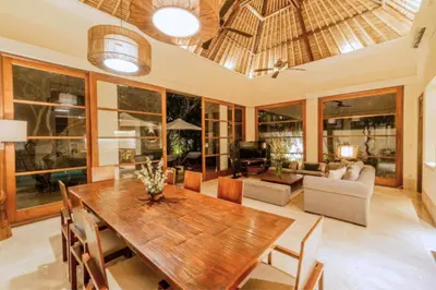 a living room with a wooden table and chairs at Majestic 3 BR Private Pool Villa NE18 in Jimbaran