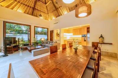 a living room with a wooden table and a dining room at Majestic 3 BR Private Pool Villa NE18 in Jimbaran