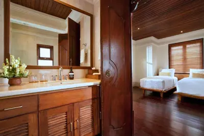 a bathroom with a sink and a bed in a room at Mandevilla 4 BR Private Pool Villa NE25 in Jimbaran