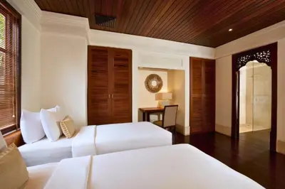 a hotel room with two beds and a table at Mandevilla 4 BR Private Pool Villa NE25 in Jimbaran