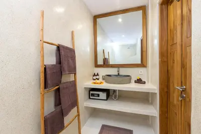 a bathroom with a sink and a mirror at Villa Kelolyne in Seminyak
