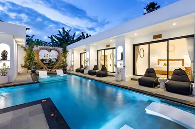 a swimming pool in a villa with a bedroom at Villa Kelolyne in Seminyak