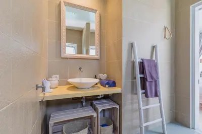a bathroom with a sink and a mirror at Cosy 3 BR villa with private pool in Seminyak in Seminyak
