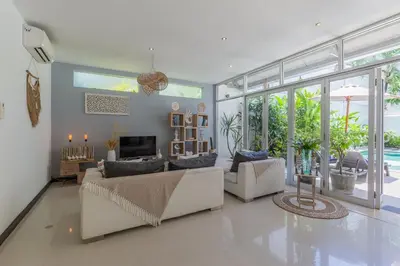 a living room with a couch and a fireplace at Cosy 3 BR villa with private pool in Seminyak in Seminyak