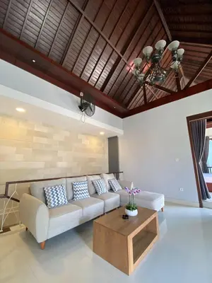 a living room with a couch and a coffee table at Villa Granatlia in Sanur