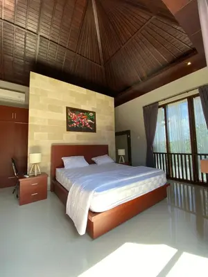 a bedroom with a large bed in a room at Villa Granatlia in Sanur