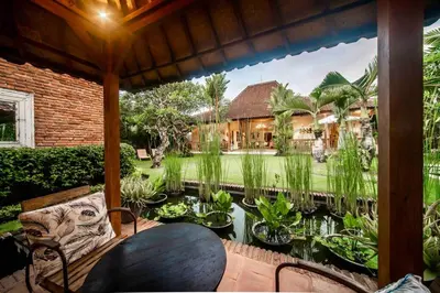 a view of a garden from the porch of a house at Villa Kuda Sumba Umalas - Seminyak Area in Kerobokan
