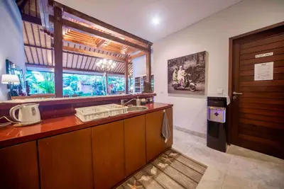 a kitchen with a sink and a window and a door at Villa Kuda Sumba Umalas - Seminyak Area in Kerobokan