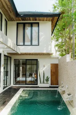 a swimming pool in the backyard of a house at LUX Casa Amore 4BR pick up from airport security PlayStation and Netflix in Seminyak