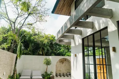 a house with a staircase in the middle of a courtyard at LUX Casa Amore 4BR pick up from airport security PlayStation and Netflix in Seminyak
