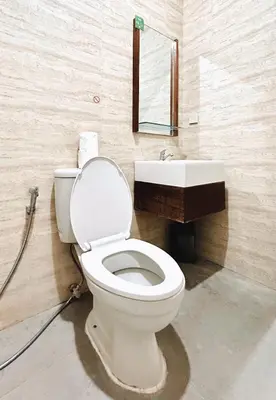 a bathroom with a toilet and a sink at Nawasena Room Suite in Sanur