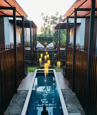 a pool with a fountain in the middle of a house at Nawasena Room Suite in Sanur