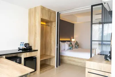a small bedroom with a bed and a glass door at Anagata 2 Tanjung Benoa Bali in Nusa Dua