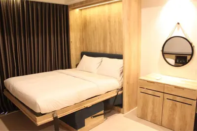 a small bedroom with a bed and a mirror at Anagata 2 Tanjung Benoa Bali in Nusa Dua