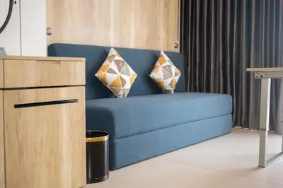 a blue couch with two pillows on it in a room at Anagata 2 Tanjung Benoa Bali in Nusa Dua