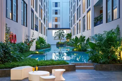 a courtyard with a pool in a building at voco Bali Seminyak by IHG in Seminyak