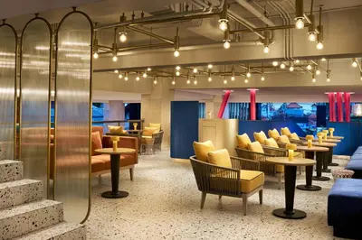 a waiting room with chairs and tables and lights at voco Bali Seminyak by IHG in Seminyak