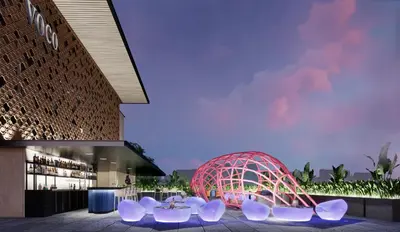 a group of white chairs in front of a building at voco Bali Seminyak by IHG in Seminyak