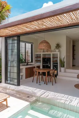 an open kitchen and dining area with a table and chairs at Casa Melosa 1 - Romantic and Cozy 1BR Villa in the Heart of Umalas in Canggu