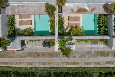 an overhead view of a building with palm trees at Casa Melosa 1 - Romantic and Cozy 1BR Villa in the Heart of Umalas in Canggu