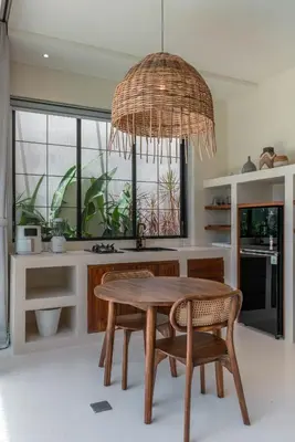 a kitchen with a table and chairs and a chandelier at Casa Melosa 2 : Charming and Intimate 1BR Villa Nestled in Umalas in Canggu
