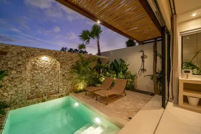 a house with a swimming pool and a patio at Casa Melosa 2 : Charming and Intimate 1BR Villa Nestled in Umalas in Canggu