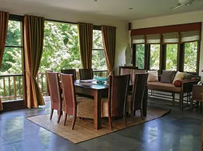 a dining room with a table and chairs at Barimantra 4BR Trees View Pool Villa CYN in Jimbaran