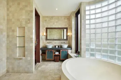 a bathroom with two sinks and a large tub at Sujiwana 2BR Luxury Jungle Pool View Villa CYN in Jimbaran