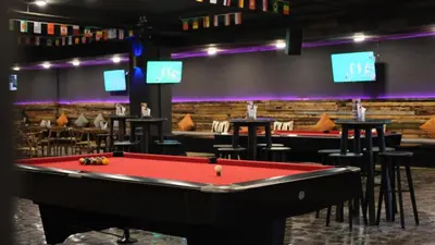 a billiard room with a red pool table at Kutabex Beachfront Hotel in Kuta