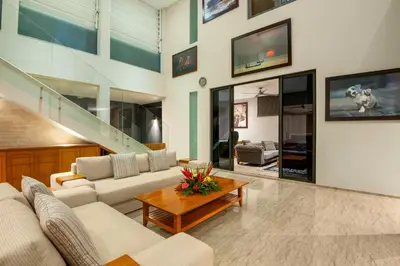 a living room with a couch and a table at Villa Eighty8 Private Residence with Gym & 20m Pool in Kerobokan