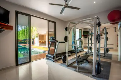 a gym with tread machines in a house at Villa Eighty8 Private Residence with Gym & 20m Pool in Kerobokan
