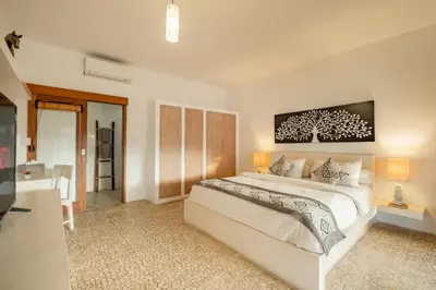 a bedroom with a large bed and a television at 3 Bedroom cozy private pool Villa in Seminyak WIFI in Seminyak