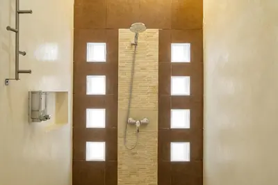 a bathroom with a shower with a glass door at 3 Bedroom cozy private pool Villa in Seminyak WIFI in Seminyak