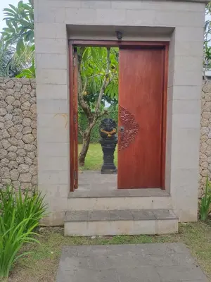 a door to a house with a vase behind it at Villa Dharmatria in Nusa Dua