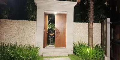a door to a house with a cat on it at Villa Dharmatria in Nusa Dua