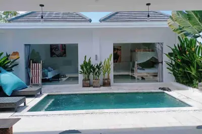 a swimming pool in front of a house at UMARA villa bali x villa aydin kerobokan bali in Seminyak