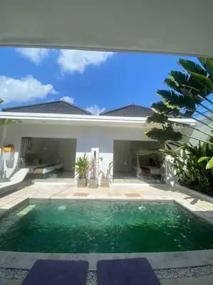 a swimming pool in front of a house at UMARA villa bali x villa aydin kerobokan bali in Seminyak