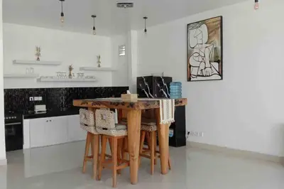 a kitchen with a wooden table and some chairs at UMARA villa bali x villa aydin kerobokan bali in Seminyak