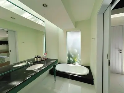 a bathroom with two sinks and a large mirror at Astana Villas in Seminyak