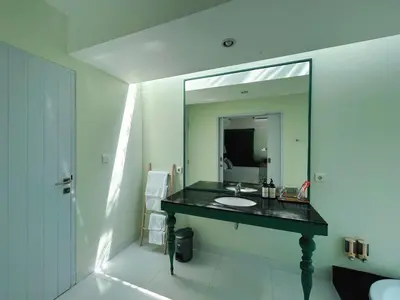 a bathroom with a sink and a mirror at Astana Villas in Seminyak