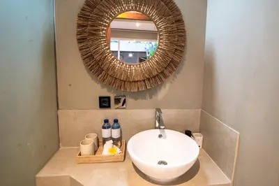 a bathroom with a sink and a mirror at Damarya Villa Canggu in Canggu