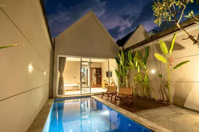 a villa with a swimming pool in a house at Damarya Villa Canggu in Canggu