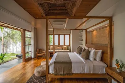 a bedroom with a bed with a wooden ceiling at Villa Zarrin Seminyak Bali Luxury 3 bedroom villa in Seminyak